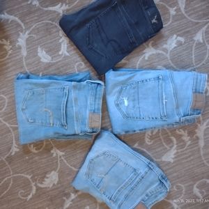 4 pairs of American Eagle skinny jeans/jeggings. 3 pairs are size 4 and 1 pair 2